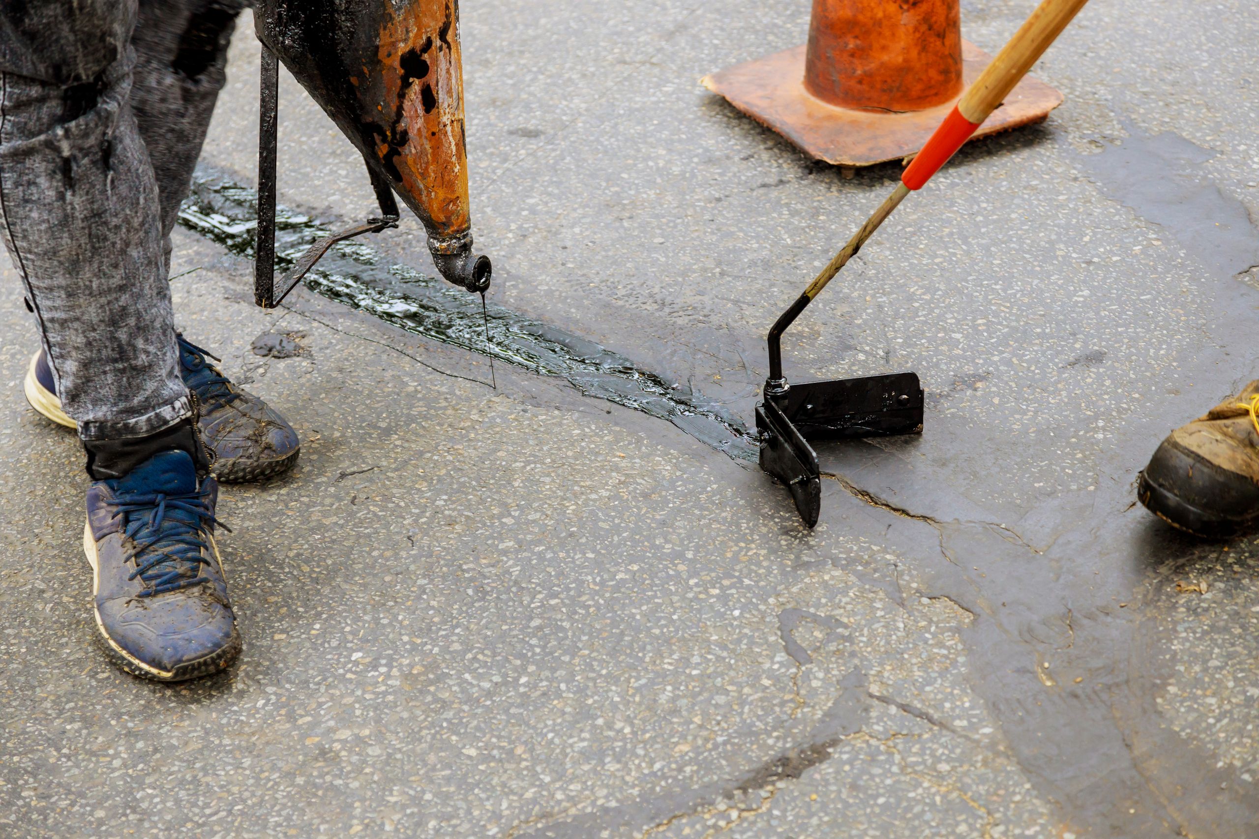 asphalt-crack-repair-with-tar-and-sealant-tools